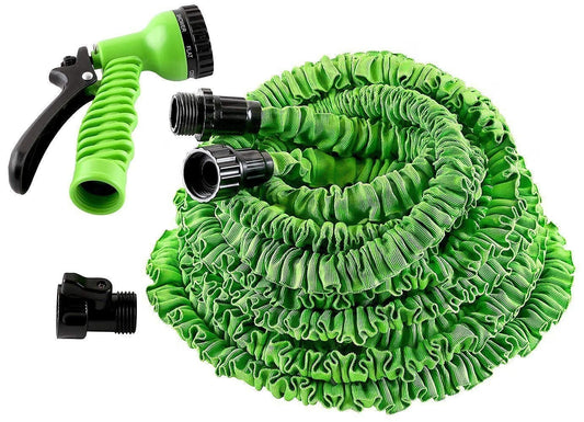 Green expandable garden hose with spray nozzle on a white background