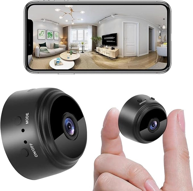 A hand holds the 19202 WiFi Security Camera for Home between two fingers, another camera rests nearby, and a smartphone displays a wide-angle living room view captured by this device.