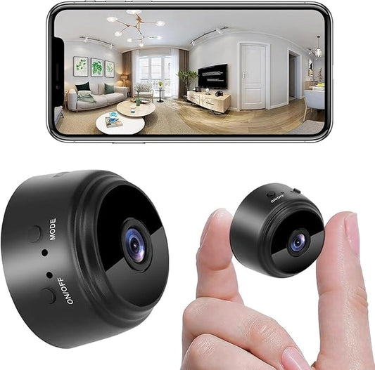 A hand holds the 19202 WiFi Security Camera for Home between two fingers, another camera rests nearby, and a smartphone displays a wide-angle living room view captured by this device.