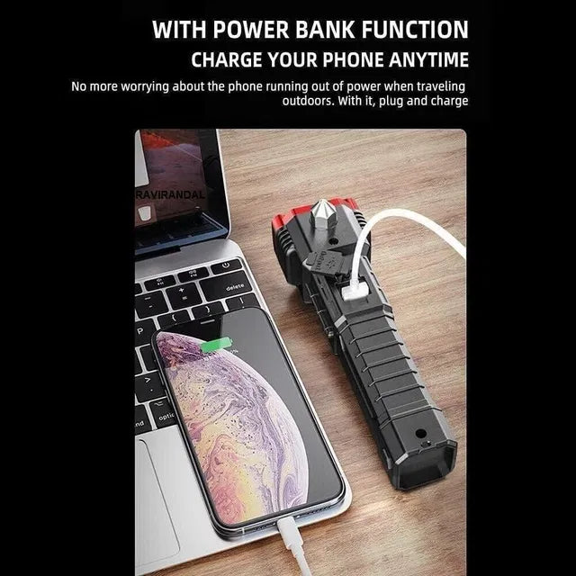 The 25478 8 in 1 Portable Rechargeable Torch LED Flashlight is shown charging a smartphone via cable beside a laptop on a wooden surface, demonstrating its power bank functionality and phone charging capability.